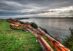 A view of the ocean across a wooden fence in Victoria, BC